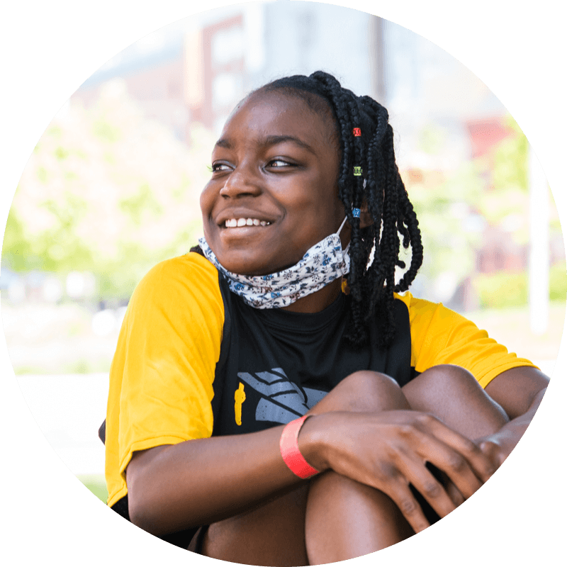 Portrait of a smiling girl from one of the 2022 traveling squash competitions.